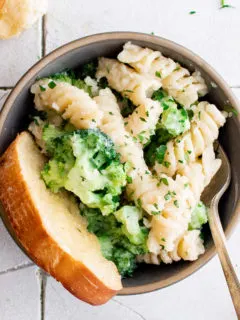 Gray bowl with pasta and broccoli.