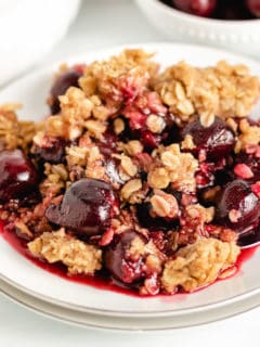 Cherry crisp with oat topping on a plate.