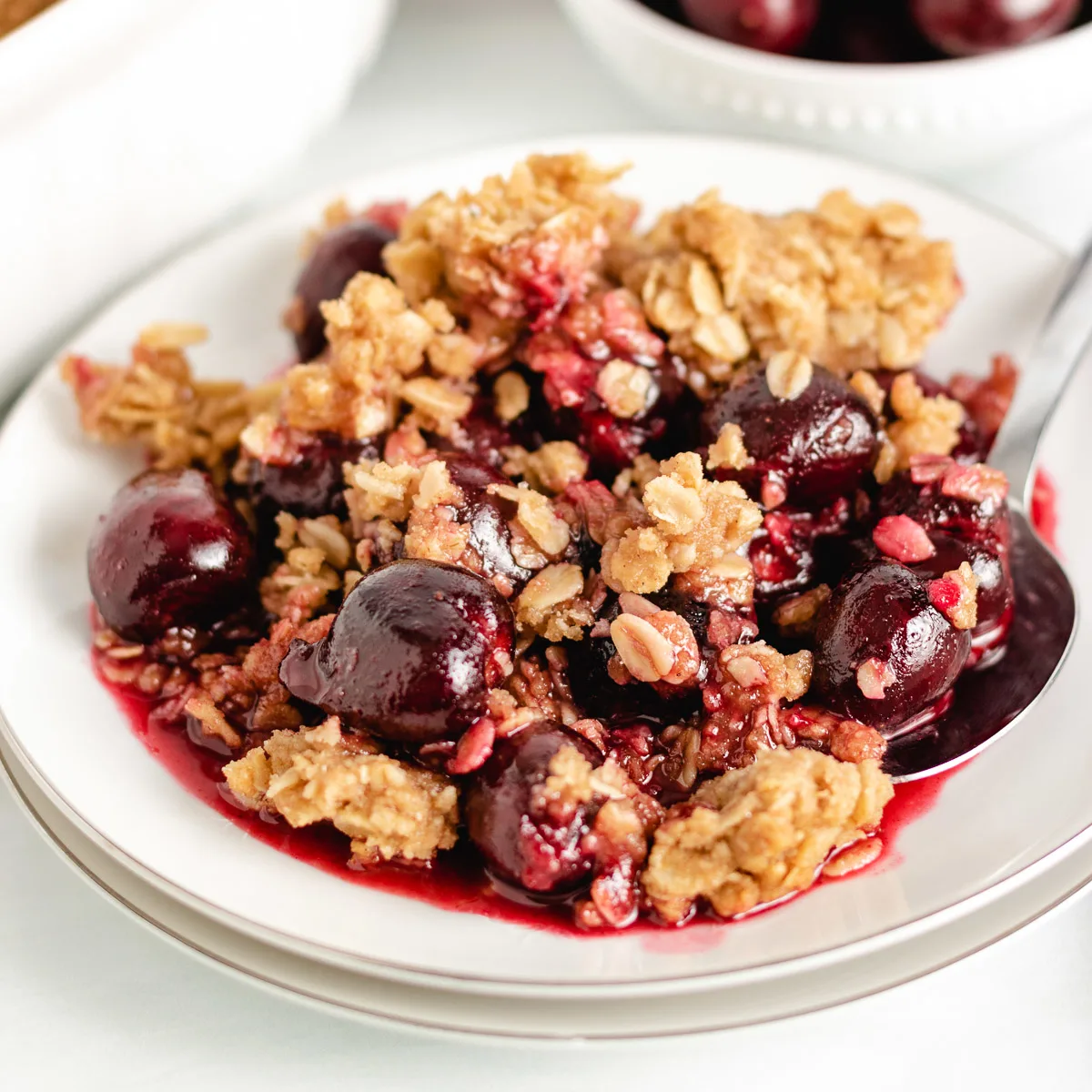 Cherry crisp with oat topping on a plate.