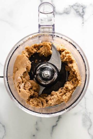 Top down view of crumble topping in a food processor.