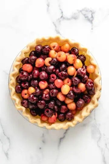 Top down view of cherry pie filling in unbaked crust.