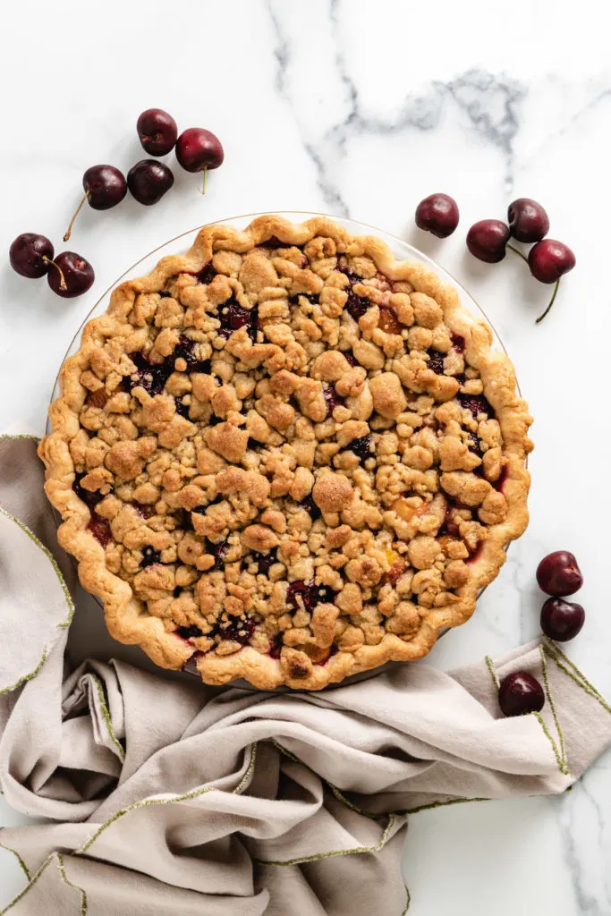 Top down view of cherry pie with crumble topping.