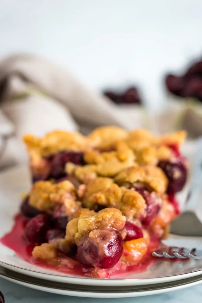 Cherry fruit pie on a small serving dish.