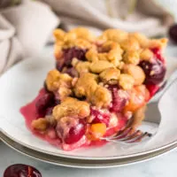 Slice of cherry pie on a plate.