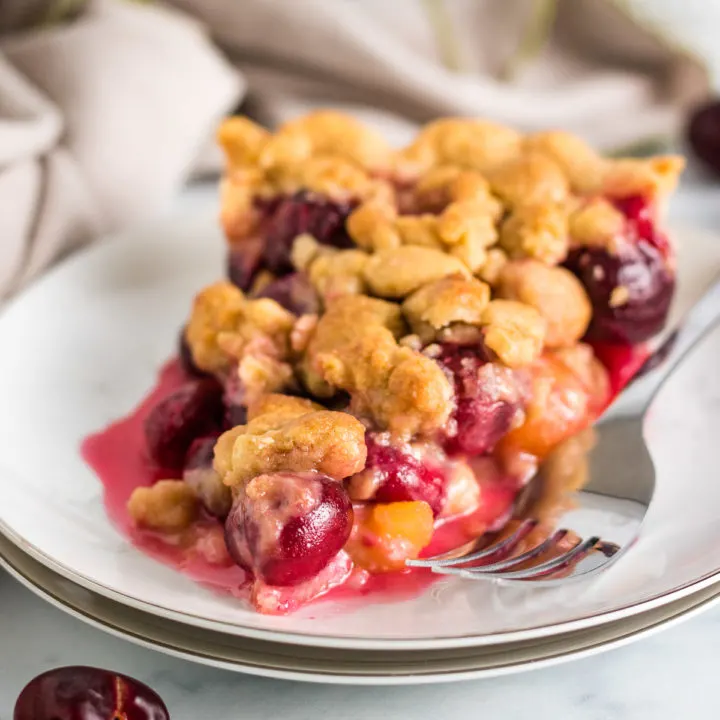 Slice of cherry pie on a plate.