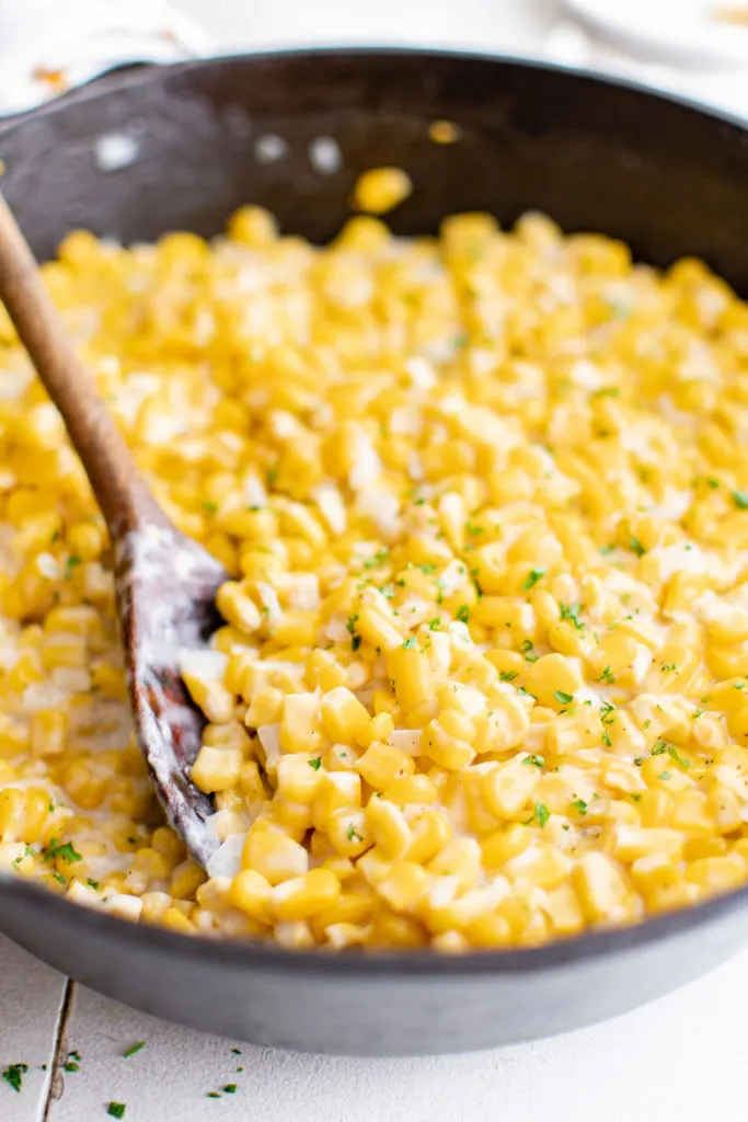 Cast iron pan full of cream corn.