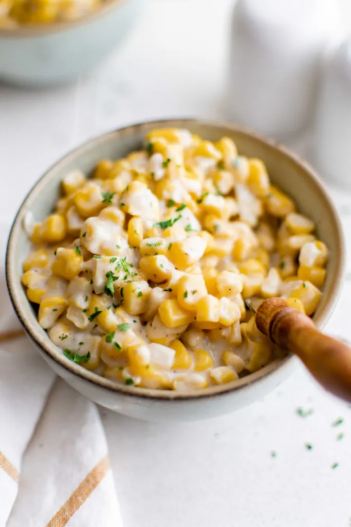 Top down view of creamed corn in a bowl.