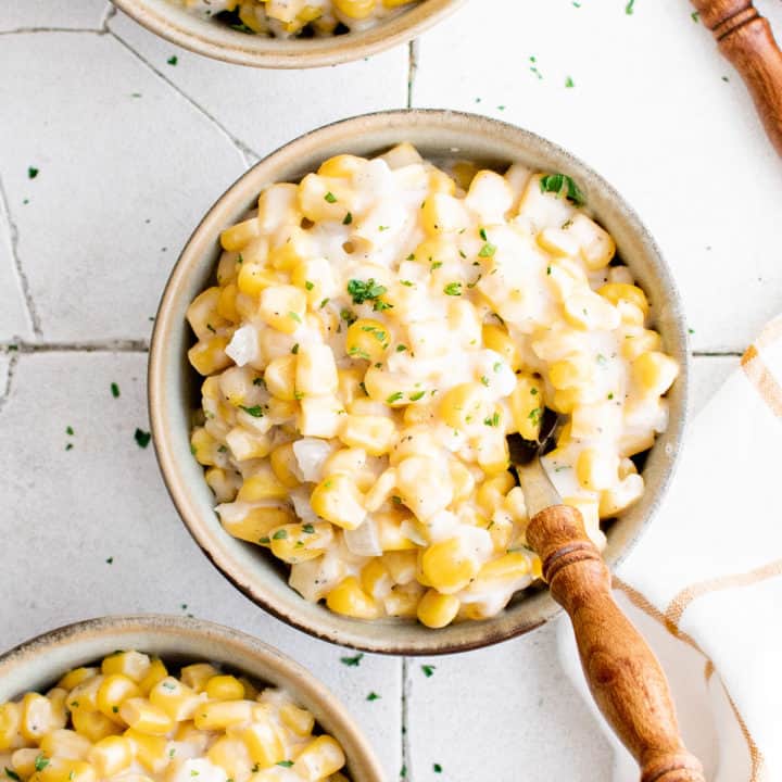 Top down view of a bowl of creamed corn in a bowl.