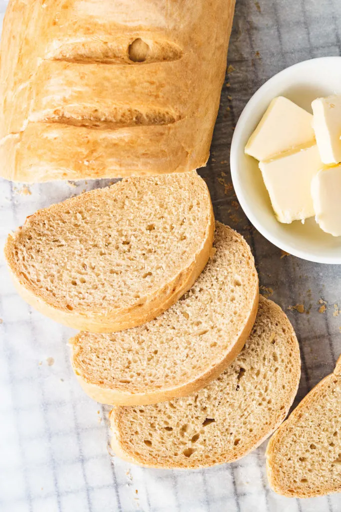 Top down view of a french loaf with butter.