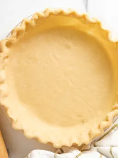 Top down view of butter pie crust in a pie pan.