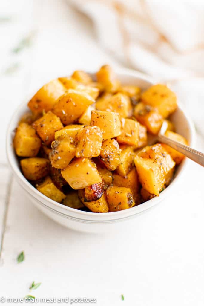 White bowl filled with roasted butternut squash.