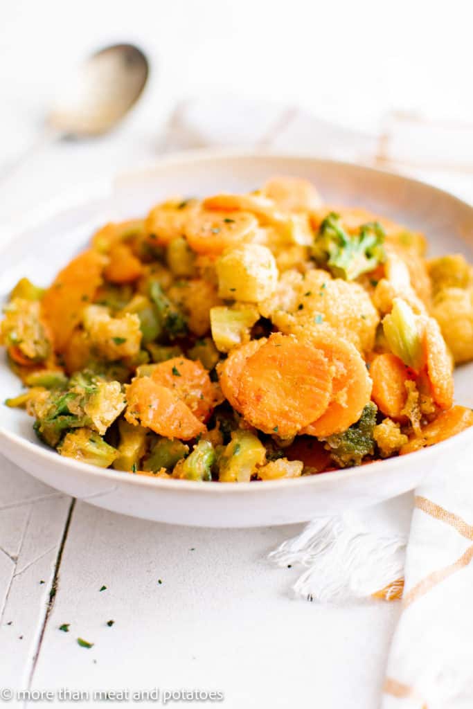 Seasoned roasted mixed vegetables on a plate.