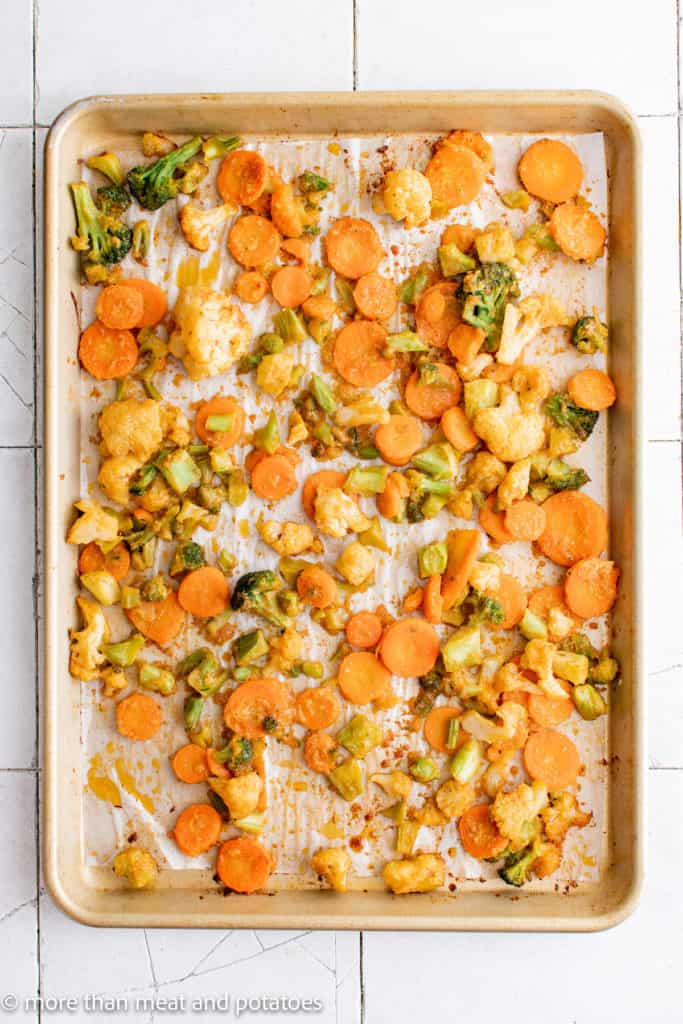Top down view of roasted vegetables on a sheet pan.