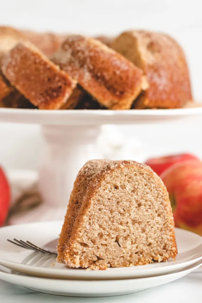 Piece of apple cider donut cake on a plate.