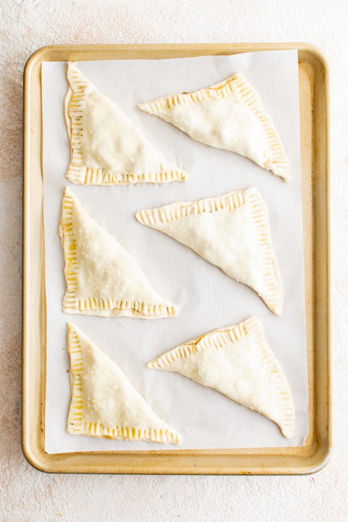 Top down view of unbaked apple turnovers.