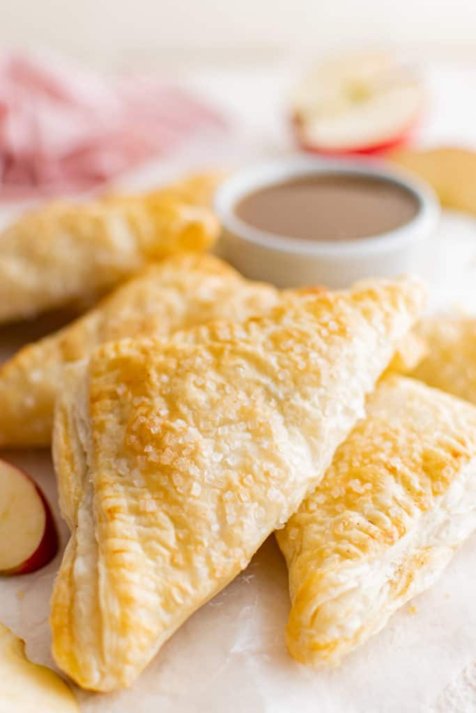 Baked apple turnovers on top of each other.