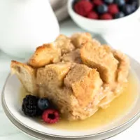 Berries and bread pudding on plates.