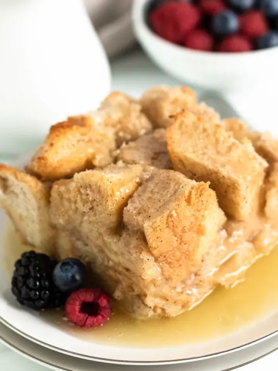 Berries and bread pudding on plates.