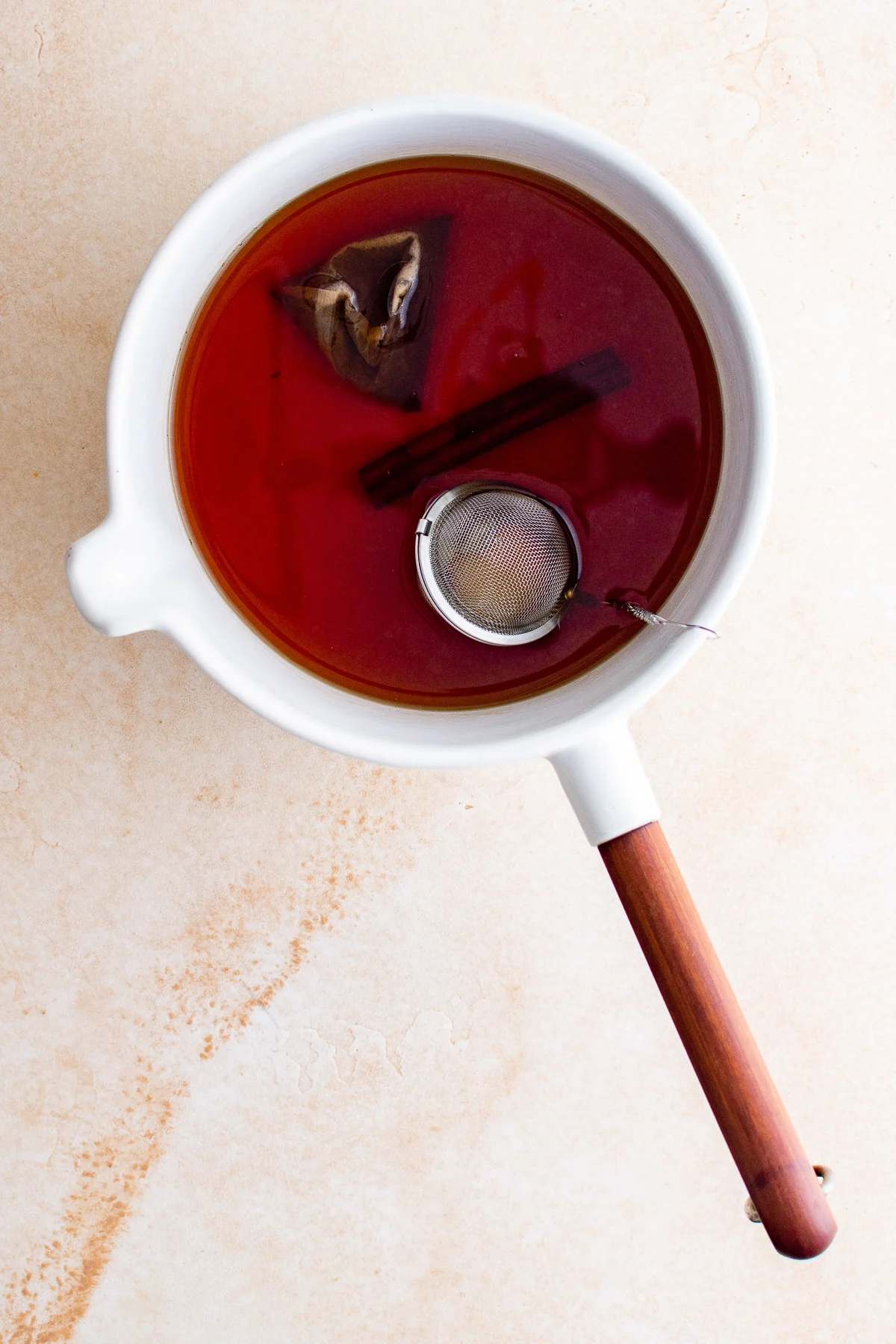 Top down view of spiced tea in a pan.