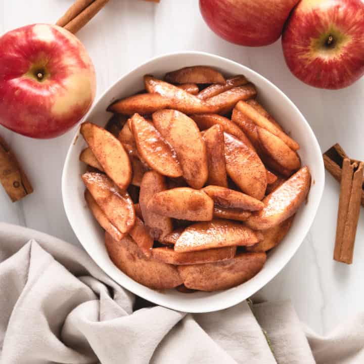 Skillet Cinnamon Apples Top down view of cinnamon apples in a white serving dish.