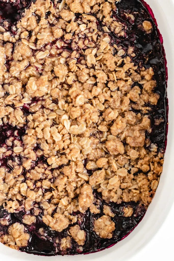 Top down view of blueberry crisp in a baking dish.