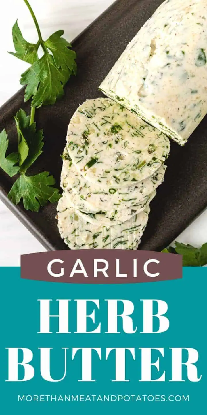 Top down view of herb butter on a black plate.