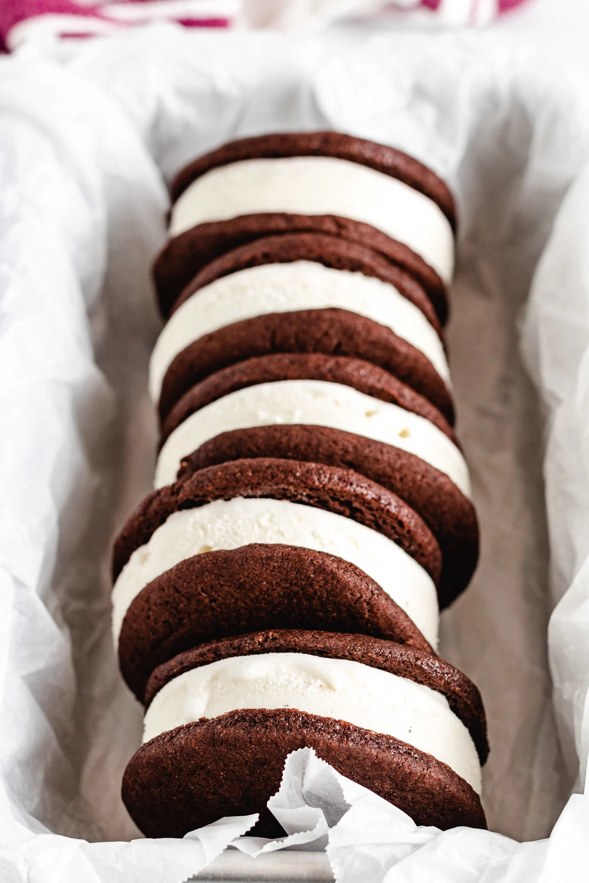 A row of ice cream sandwiches in a metal pan.