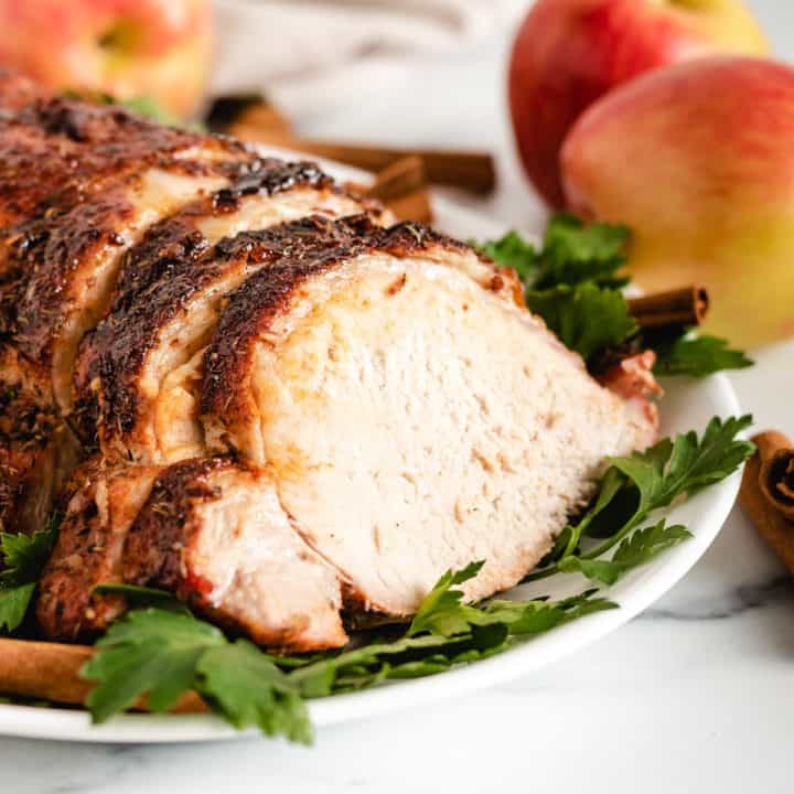 Apple Cider Marinated Pork Loin Roasted pork loin sliced on a platter.