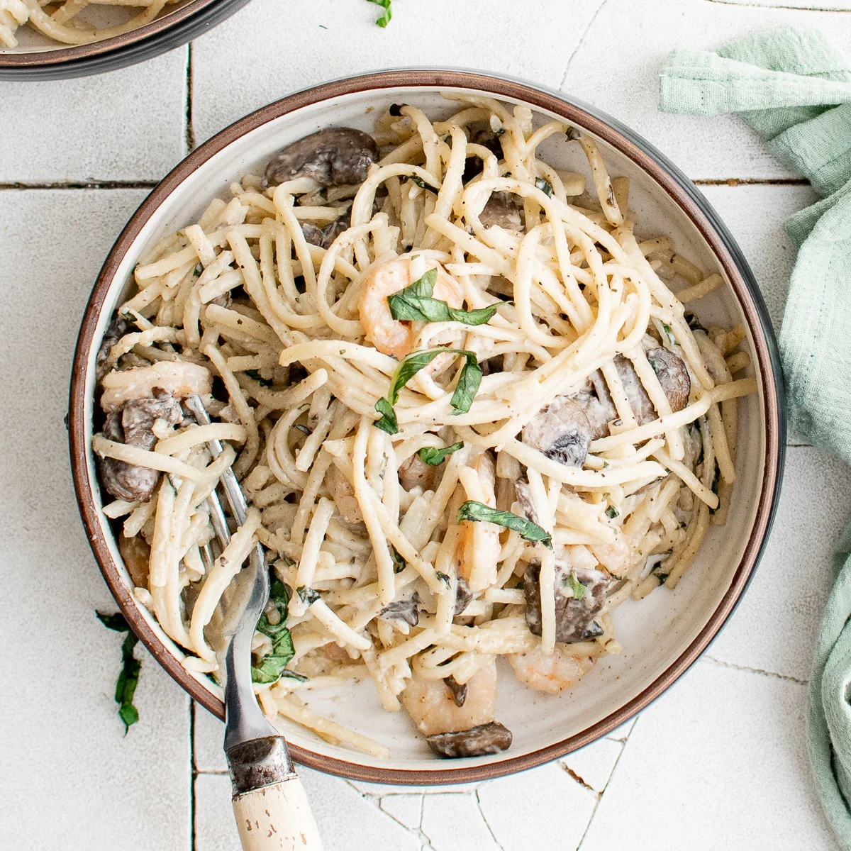 Top down view of mushroom shrimp pasta on a plate.