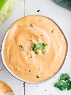 Close up of chipotle mayo and limes.