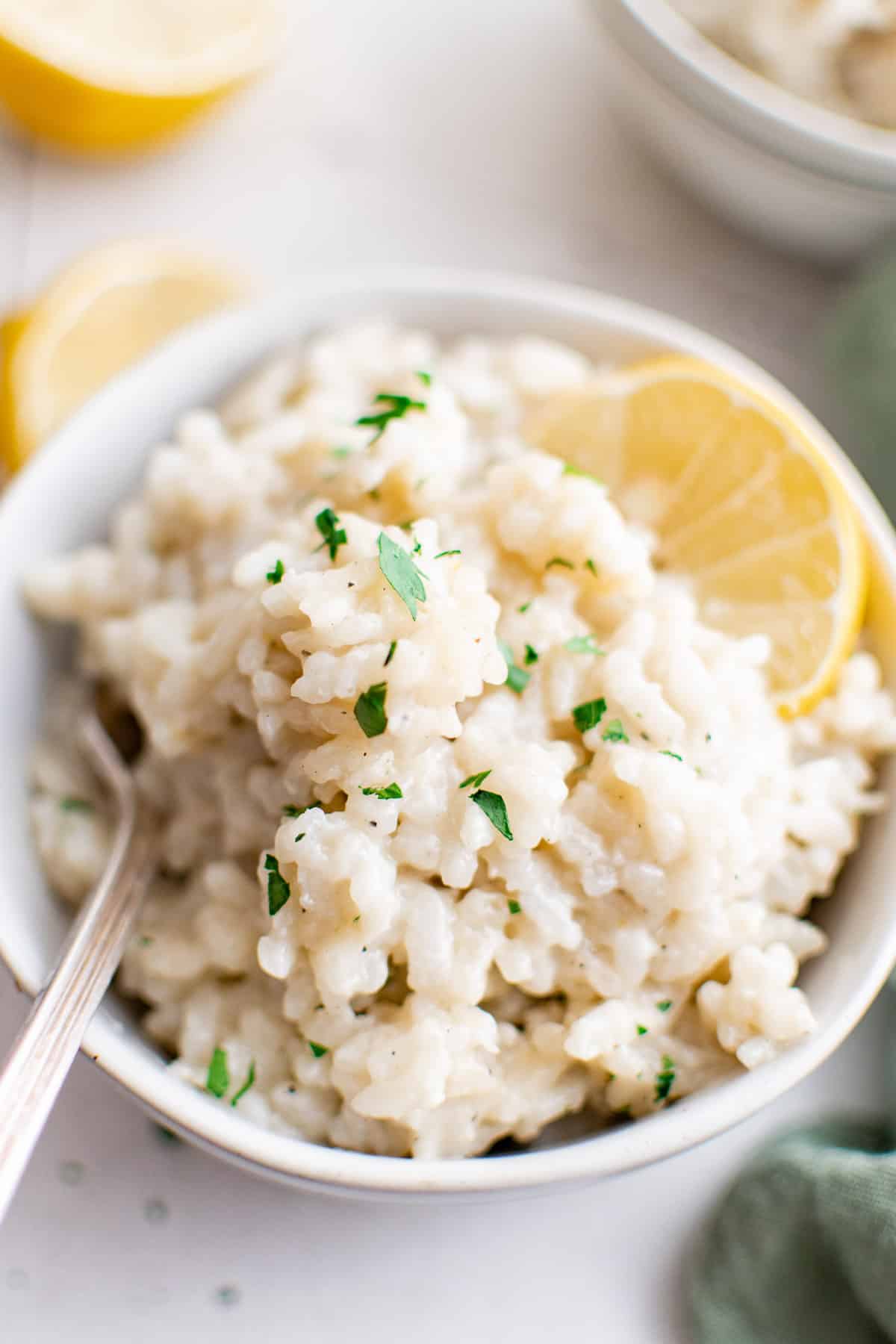 Top down view of Parmesan risotto with a lemon slice.
