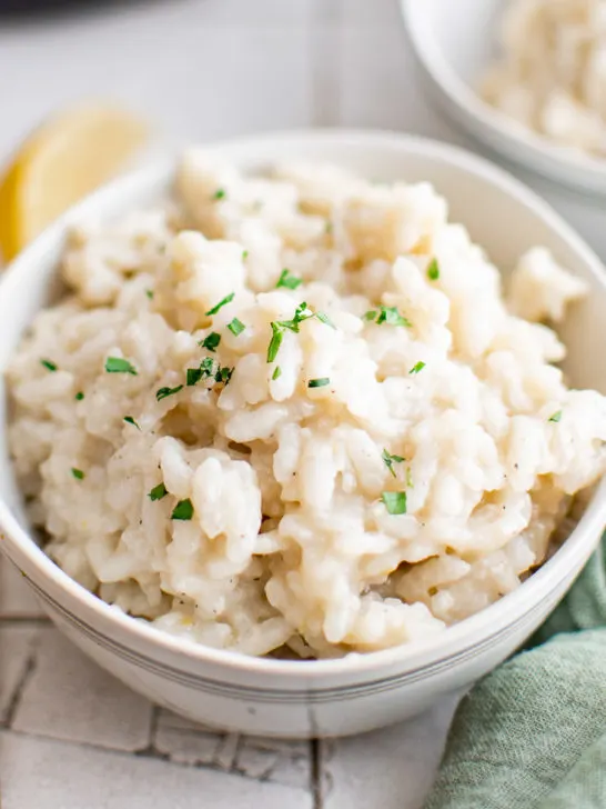 White bowl filled with creamy Parmesan risotto.