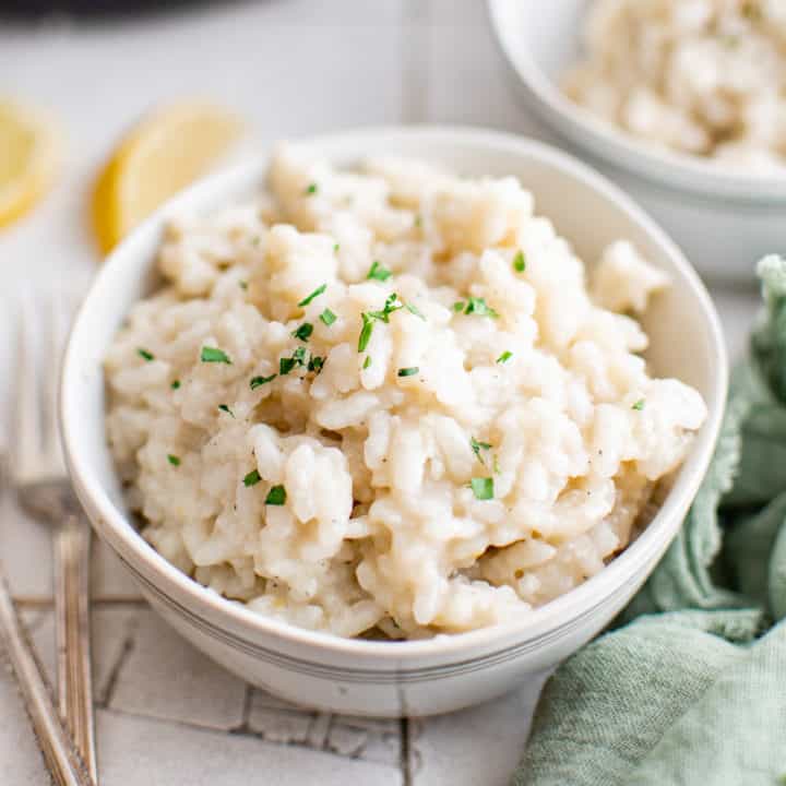 White bowl filled with creamy Parmesan risotto.
