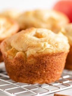 Apple cinnamon muffins on a wire rack.