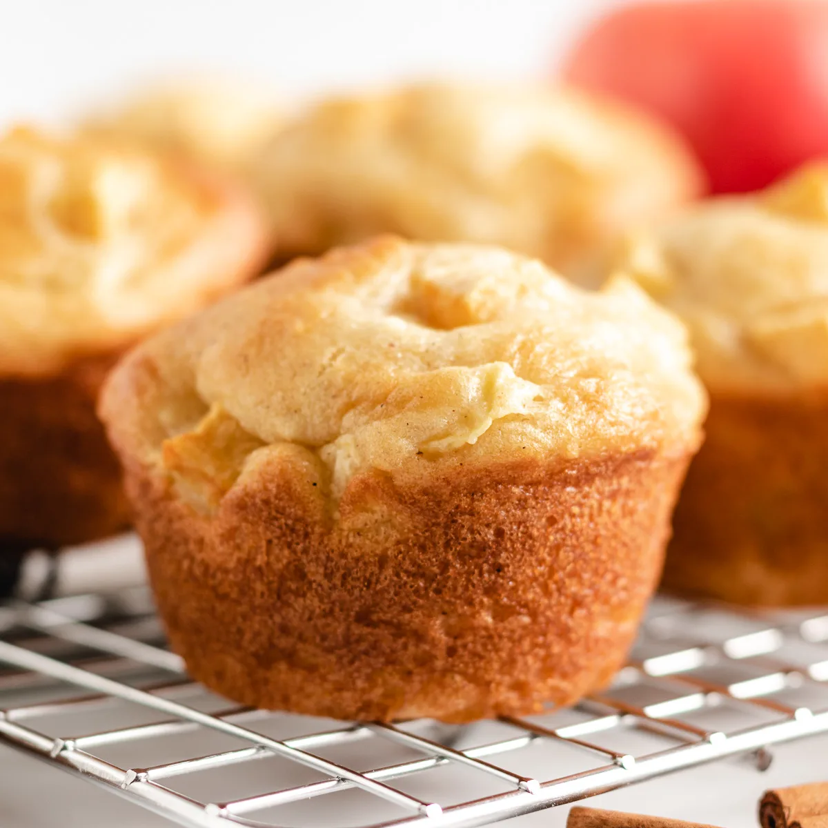 Apple cinnamon muffins on a wire rack.