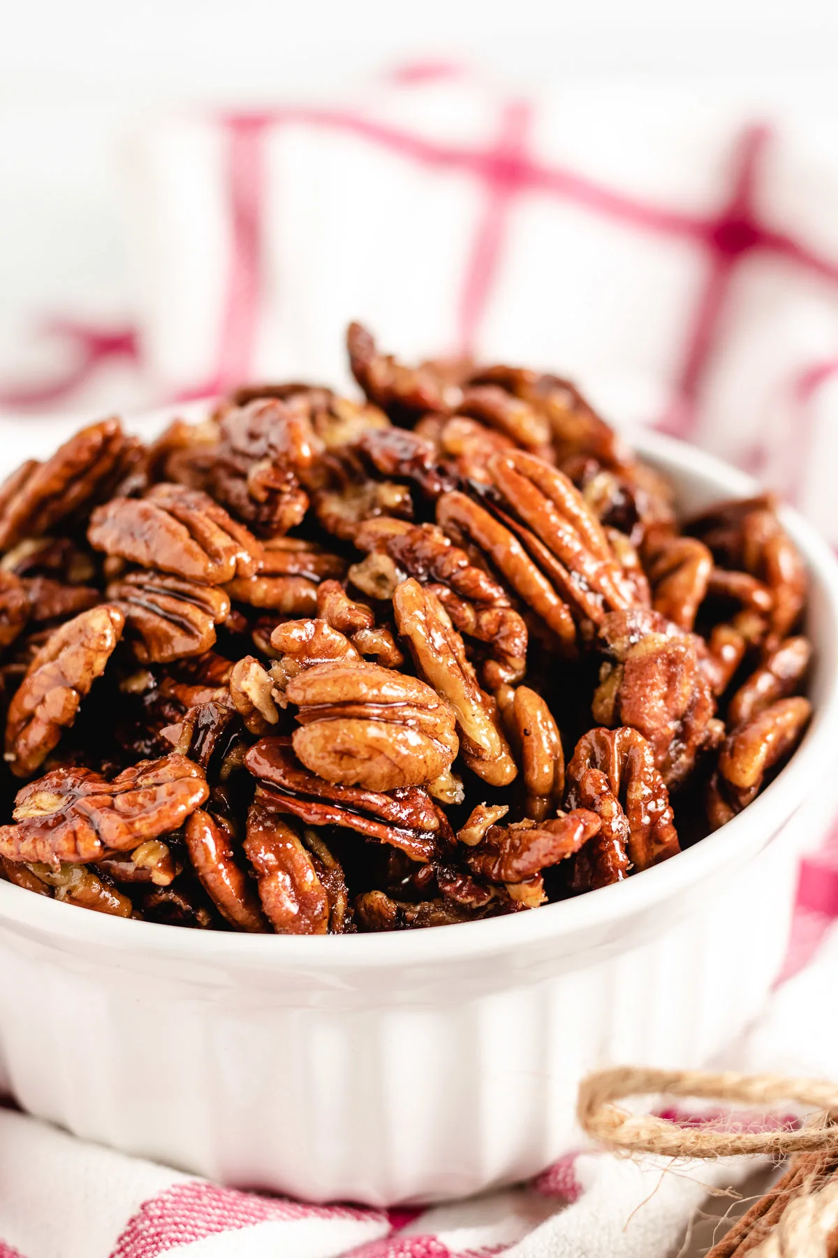 White dish with maple cinnamon pecans.