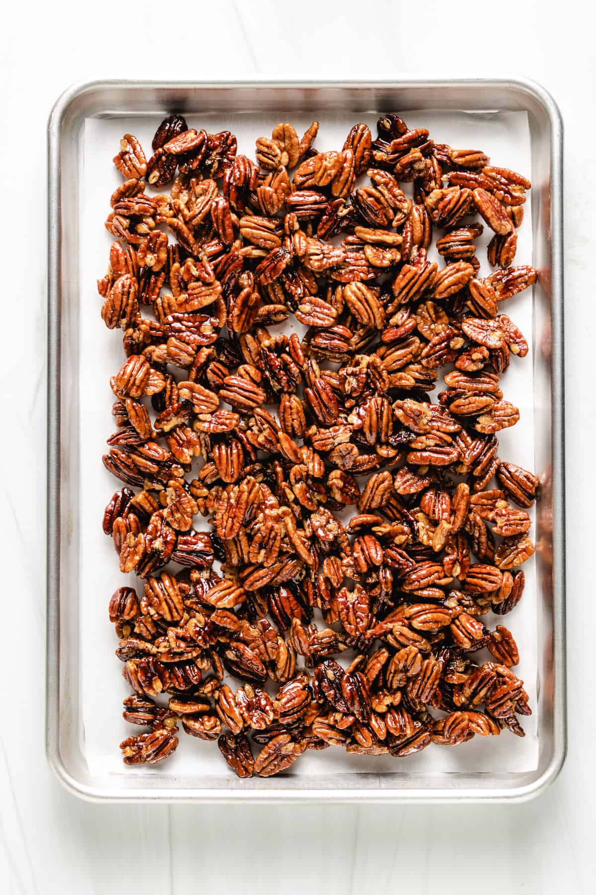 Baking sheet filled with maple pecans.