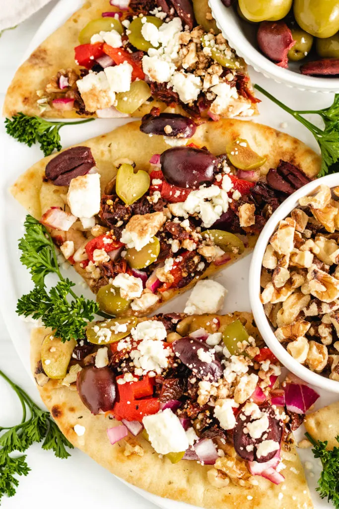 Greek bread with a bowl of walnuts.