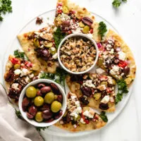 Top down view of sliced naan bread with toppings.