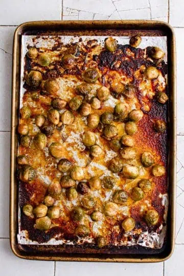 Top down view of roasted brussel sprouts on a pan.