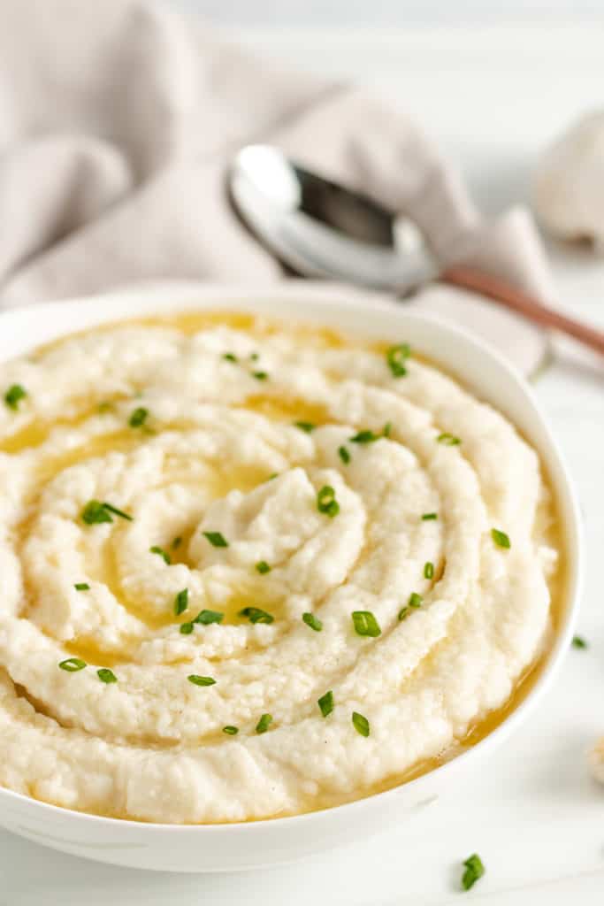 Mashed cauliflower in a white bowl.