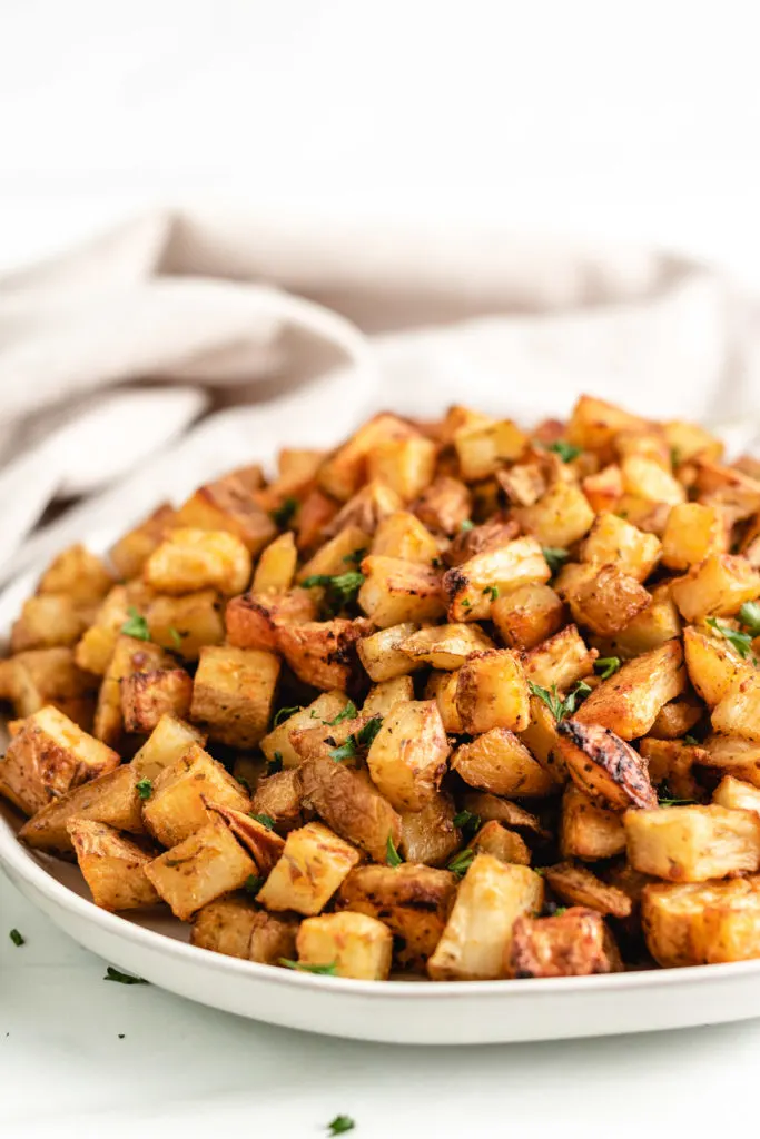 Seasoned potatoes on a serving plate.