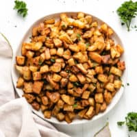 Top down view of a plate of roasted potatoes.