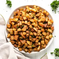 Top down view of a plate of roasted potatoes.