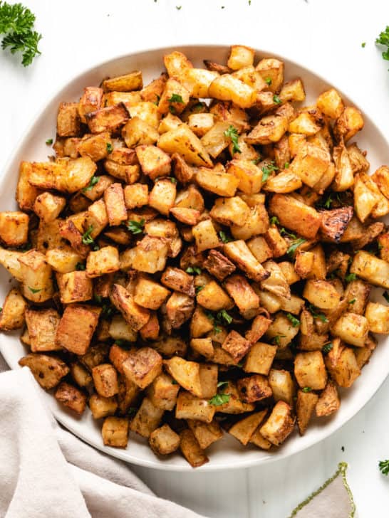 Top down view of a plate of roasted potatoes.