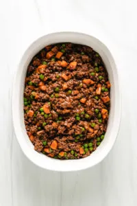 Top down view of meat filling in a casserole dish.