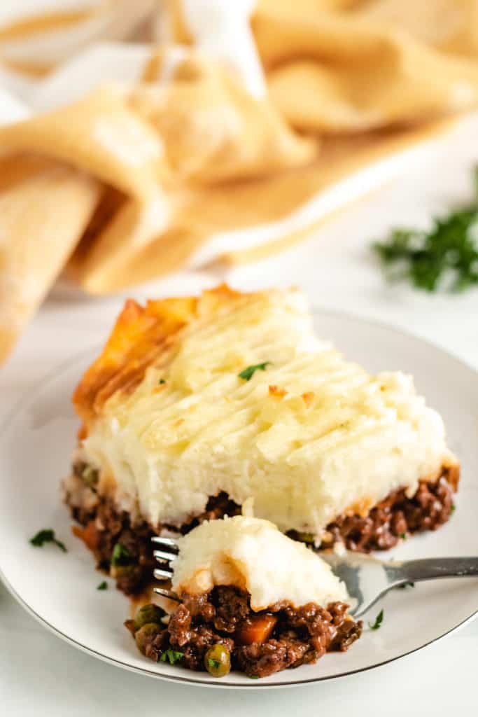 Serving of shepherd's pie on a white plate.
