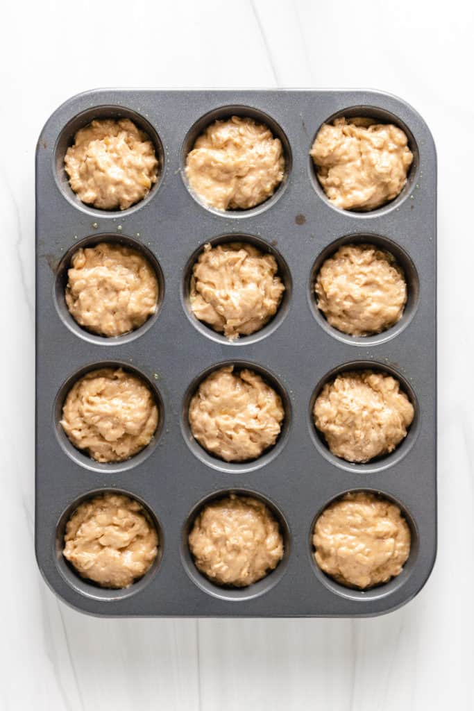 Top down view of unbaked banana muffins with oatmeal.