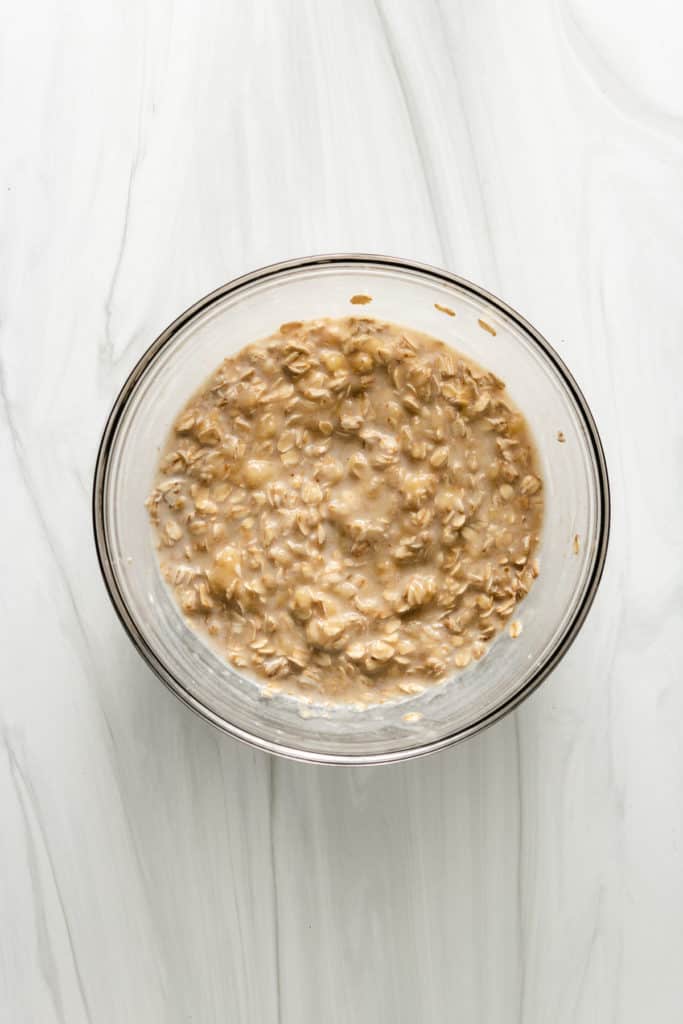 Top down view of mashed bananas mixed with oats.