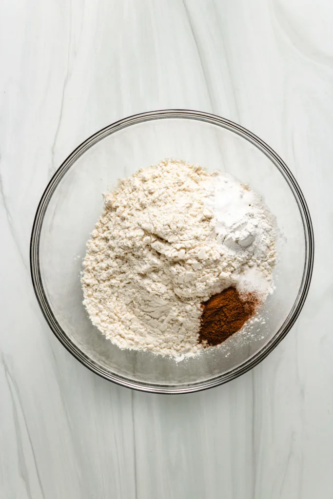 Flour, spices, and baking in a glass bowl.